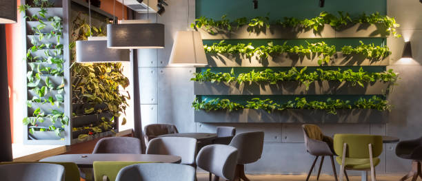 istock Empty cafe interior with lots of greenery on walls 1208525537