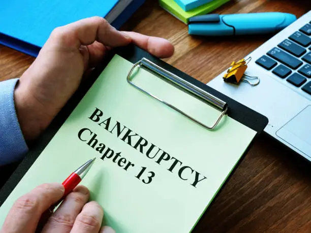 Man reads bankruptcy chapter 13 law in the office.