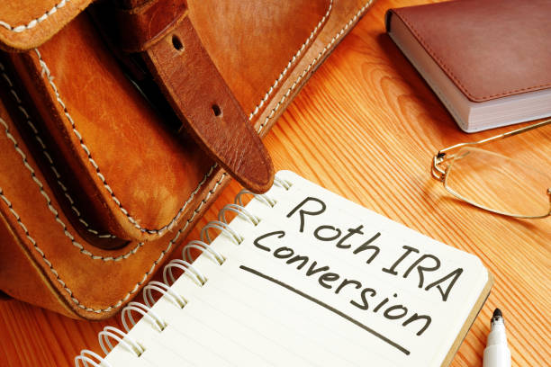 istock Roth ira conversion memo near retro briefcase and glasses. 1208527071