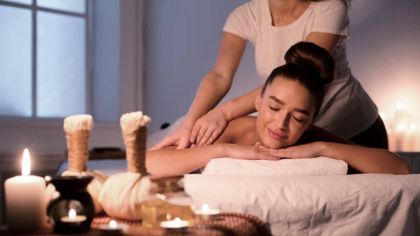istock Woman receiving back massage, enjoying evening in spa 1208528670