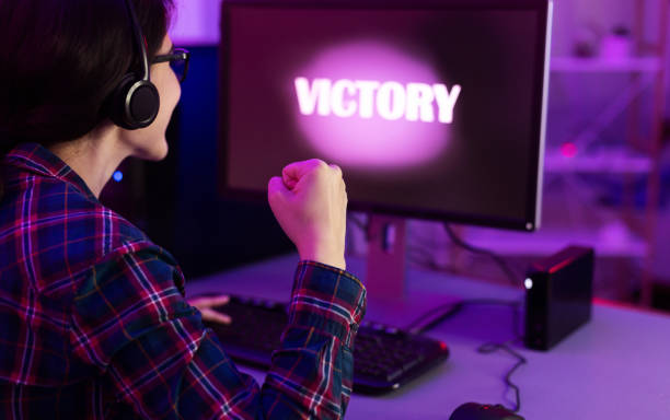 istock Gamer Girl Winning Computer Game Sitting At PC Indoor, Rear-View 1208528761