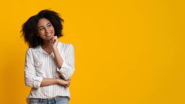 istock Pensive Afro Woman Smiling And Looking Aside At Copy Space 1208529074