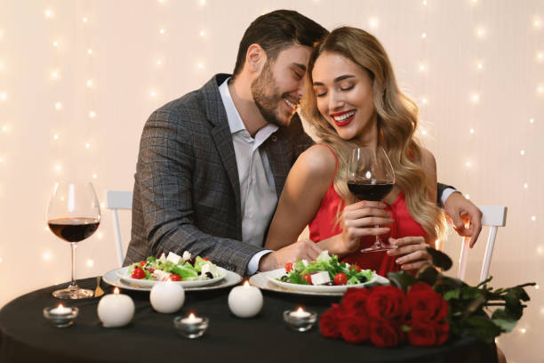 istock Passionate couple dining in restaurant, drinking wine and having romantic moments 1208529244
