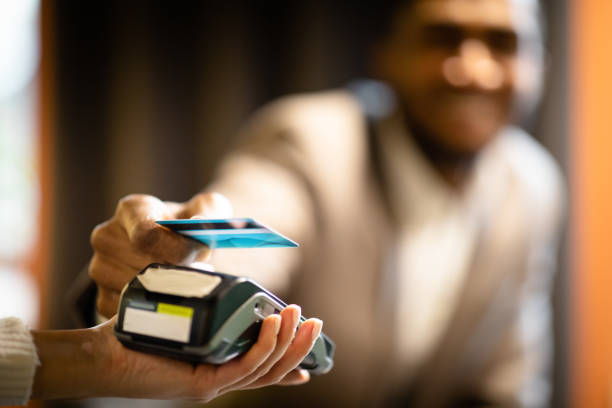 istock Afro businessman using modern contactless system at bar 1208529408