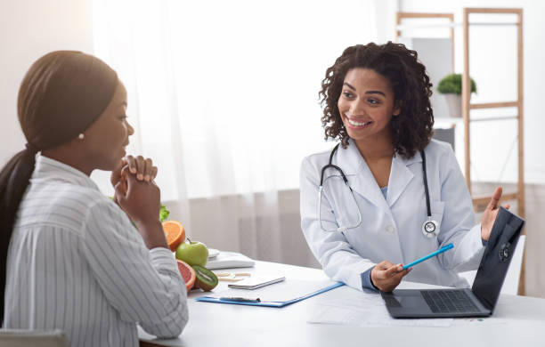 istock Dietologist using laptop in office, making patient's anamnesis 1208529581