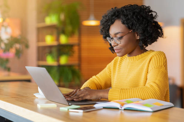 istock Female blogger working at cafe, using laptop 1208529639