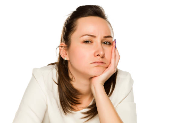 Bored unhappy woman with no makeup on white background
