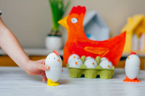 istock Close up of child playing with Easter chickens from eggs 1208532099