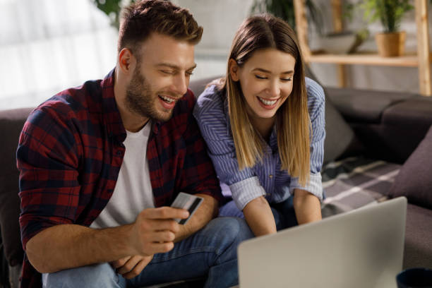istock Young affectionate couple shopping online using laptop 1208532237