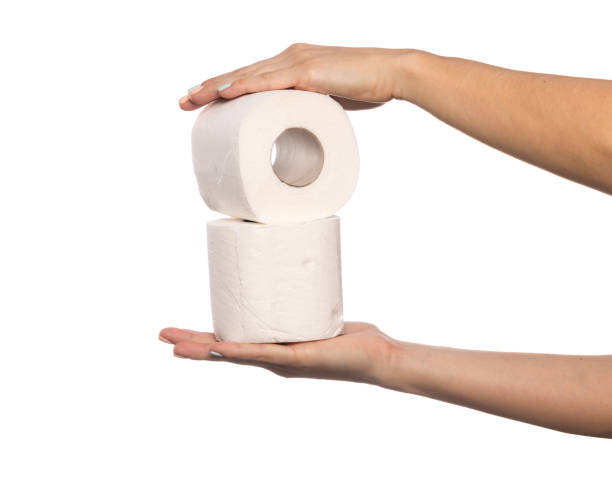 istock Hand holding toilet paper isolated on white background with clipping path. 1208533079