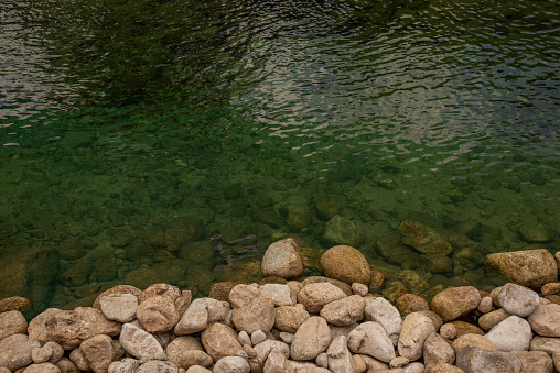 many stones and clear water at the river