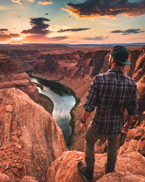istock man resting at horseshoe bend in usa 1208535029