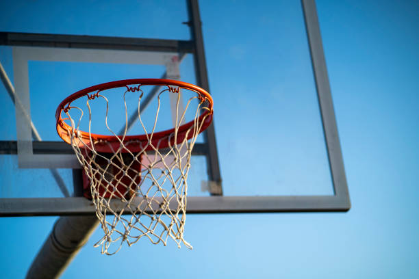 Basketball rim in a blue sky background stock photo