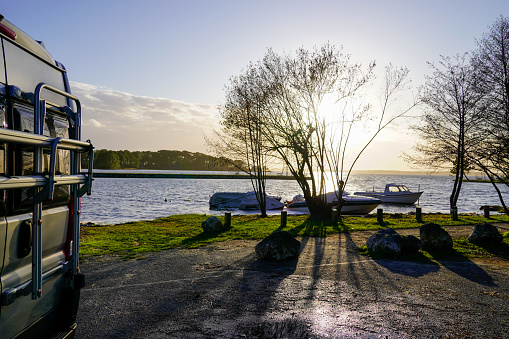 camper van rv by the lake in sunset vanlife morning sunrise