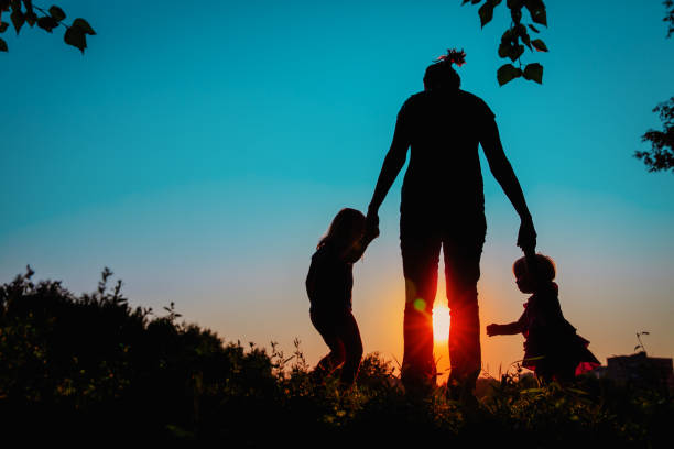 istock mother with kids walk in sunset nature 1208539092