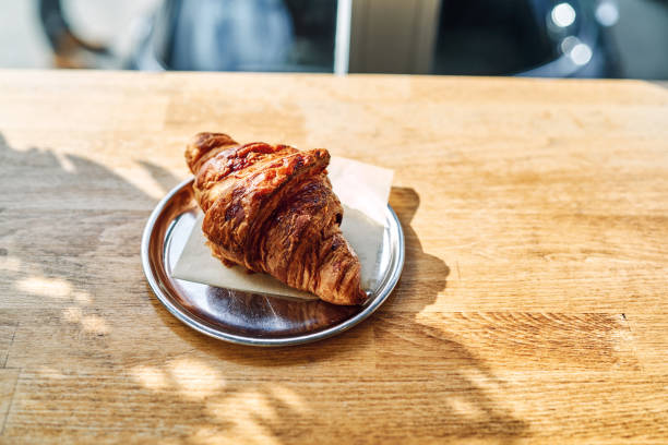 fresh baked croissant on plate with copy space . High quality photo