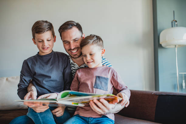 istock Father is reading a book to his sons 1208539852