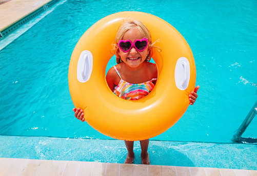 cute happy little girl have fun at the pool, kids on vacation