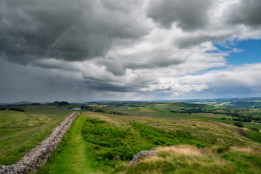 Storm clouds approach Hadrian's Wall, the ancient boundary between England and Scotland.