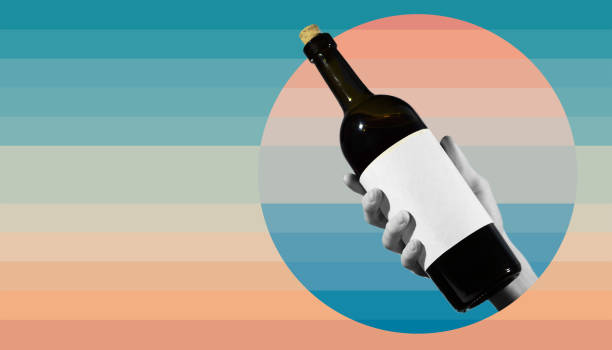 istock Hand hold red wine bottle with a white textural label on a collage concept, contemporary colors and mood social background. 1208541335