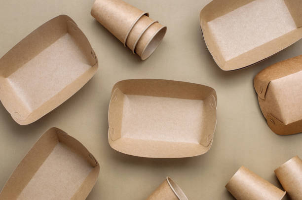 istock Brown kraft paper food containers on beige background 1208543062