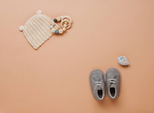 istock Wooden teether, clothes and shoes on beige background 1208543260