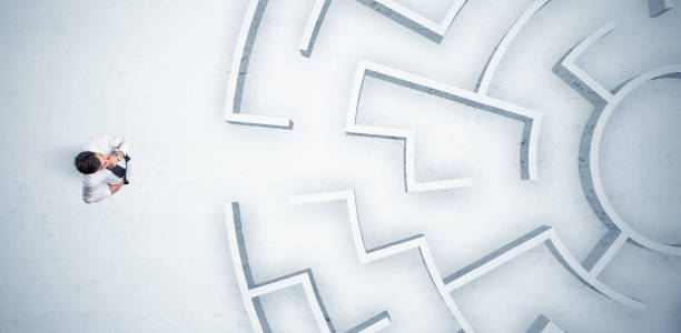 istock Business man looking at circular maze with nowhere to go 1208545581