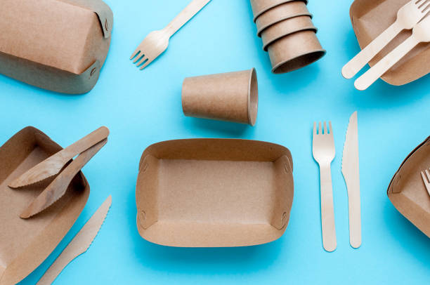 istock Brown kraft paper food containers on blue background 1208545773