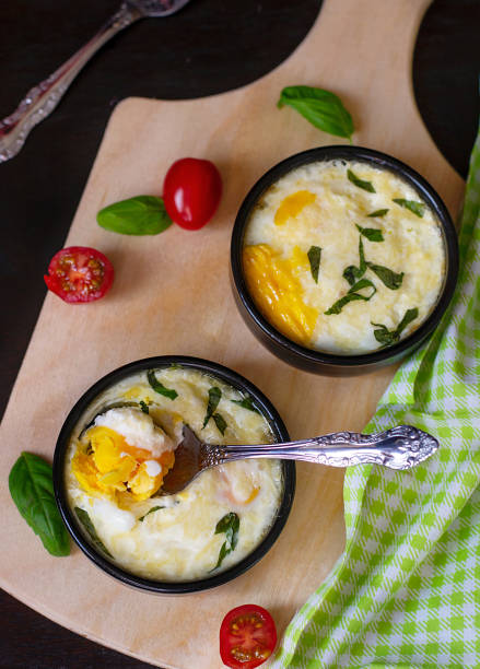 istock Baked shirred eggs with cheese served with basil 1208545847