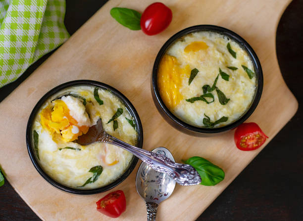 istock Baked shirred eggs with cheese served with basil 1208545850