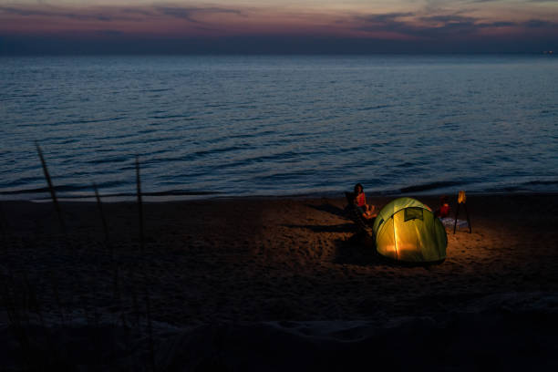 istock Camping with friends at the beach 1208549187