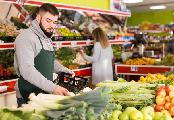 istock Market worker puts onions on the counter 1208549225