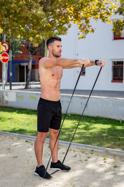 istock Man doing calisthenic exercises in a public park 1208549421
