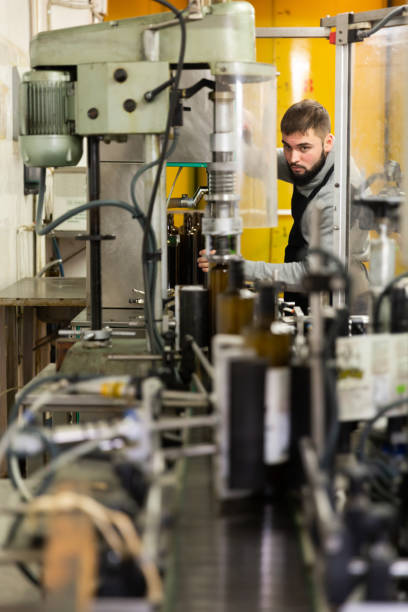 istock Guy working on olive oil bottling conveyor 1208550069