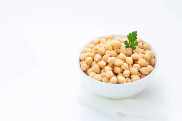 Photo of Chickpeas on  plate, isolated on  white background.