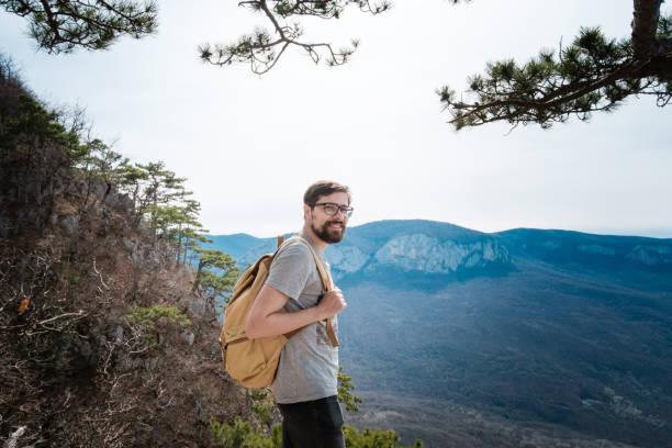 istock young hipster man in the spring mountains 1208551732