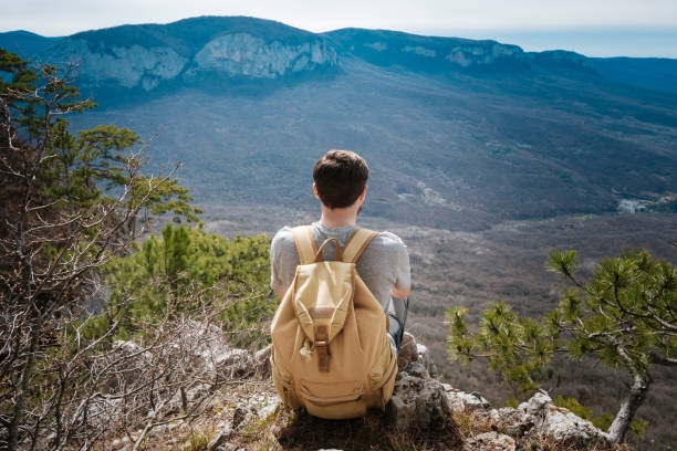 istock young hipster man in the spring mountains 1208551738