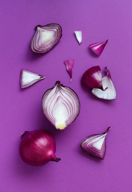 istock Purple onion on a purple background top view 1208553454