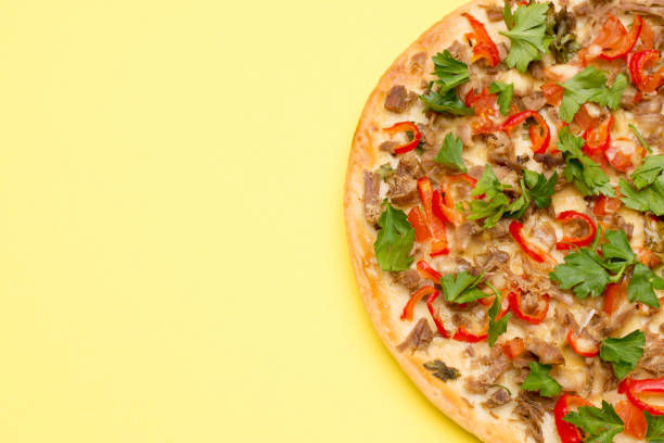 istock Hot delicious pizza on summer yellow background with a copy space. 1208553855