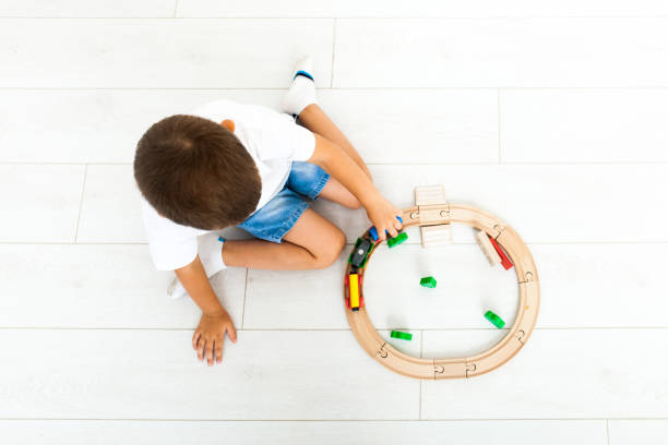 istock little boy playing with toy train at home 1208554667