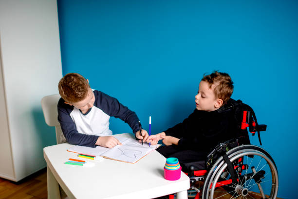 istock A boy and a boy in wheelchair learn at home 1208554694