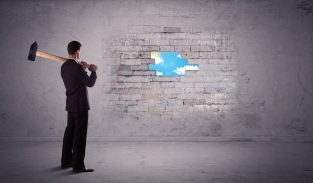 istock Business man hitting brick wall with hammer 1208554750