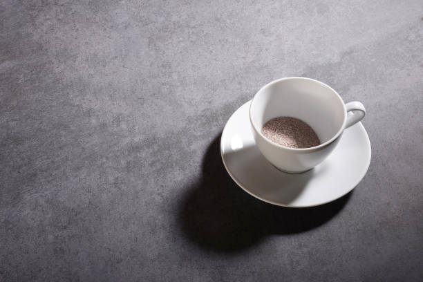 istock High angle view instant coffee granules in a porcelain coffee cup on the gray stone texture with copy space 1208555128
