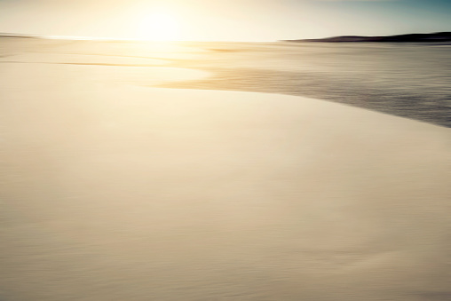 Beach background blurred motion, defocused sand