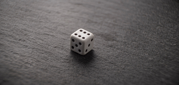 White dice in textured black background