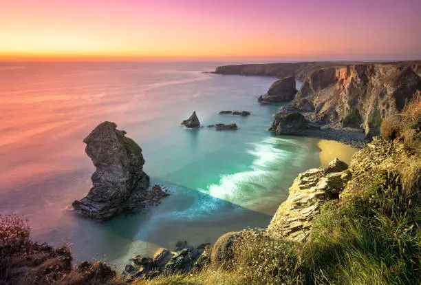 Sunset at Bedruthan Steps. Carnewas and Bedruthan Steps is a stretch of coastline located on the north Cornish coast between Padstow and Newquay, in Cornwall, England, United Kingdom