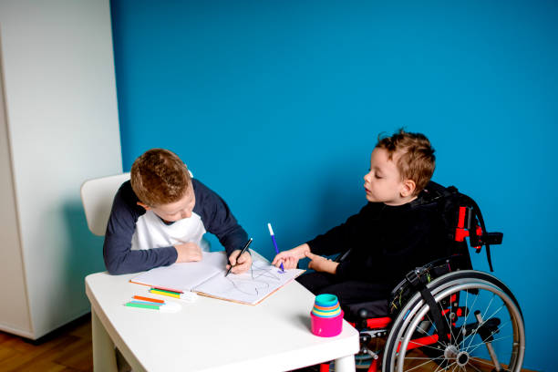 istock A boy and a boy in wheelchair learn at home 1208558123