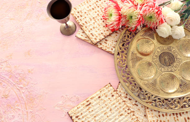 istock Pesah celebration concept (jewish Passover holiday). Traditional pesah plate text in hebrew: Passover, horseradish, celery, egg, bone, maror, charoset 1208559118