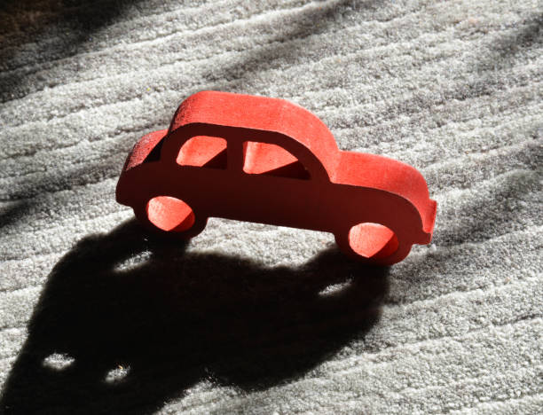istock red wooden toy car on grey background 1208559282