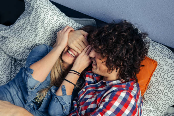 istock Couple playing and laughing on the bed 1208561144